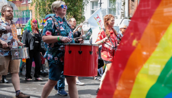 Pride parade marching through Ashford