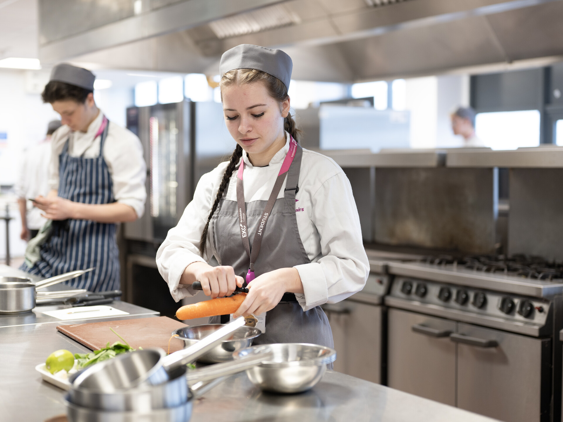 2 people in a kitchen preparing food