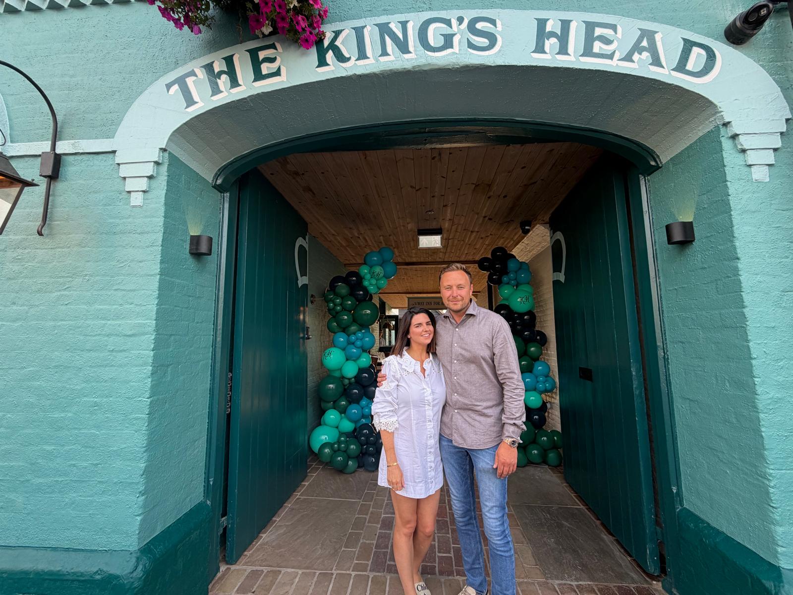 New owners standing outside the pub