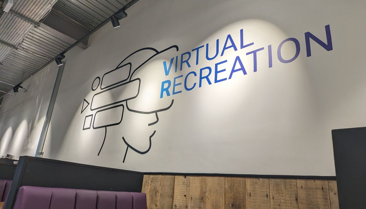 The Virtual Recreation logo on the wall inside their business