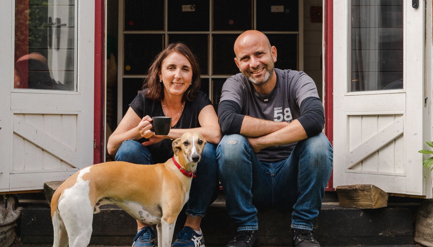 Owners, Maya and Shai sitting with their dog